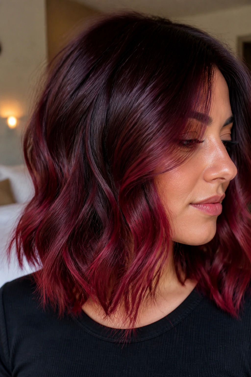 Close-up of a woman with red velvet fade ombre and soft waves