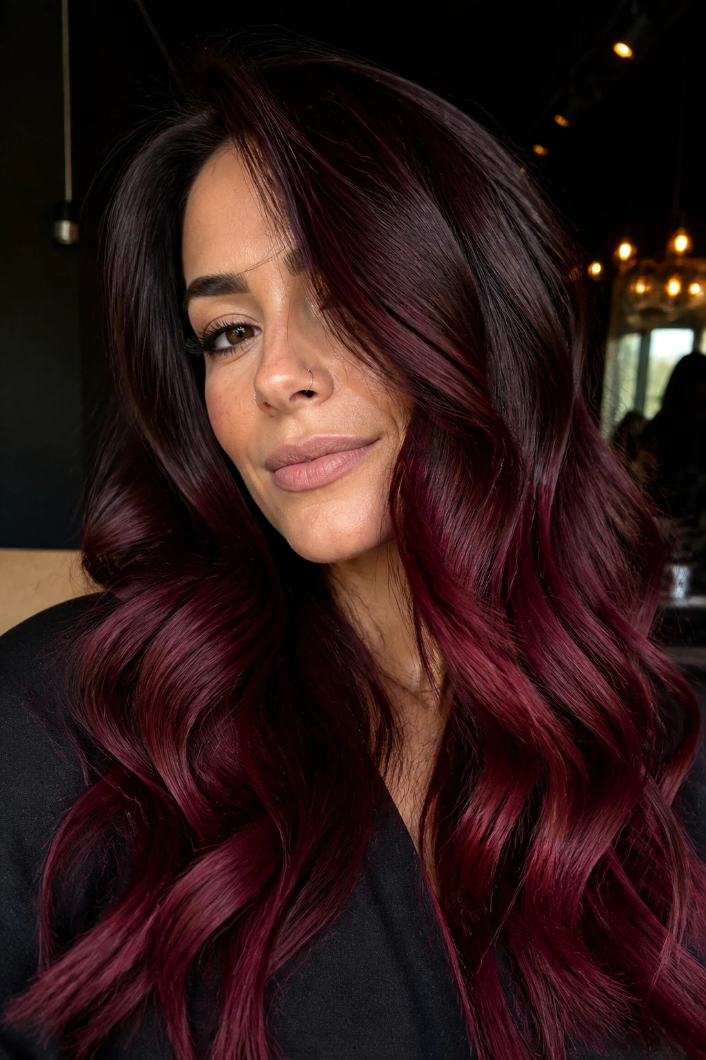 Close-up of red wine to cherry cola ombre on a real woman's burgundy-to-red hair