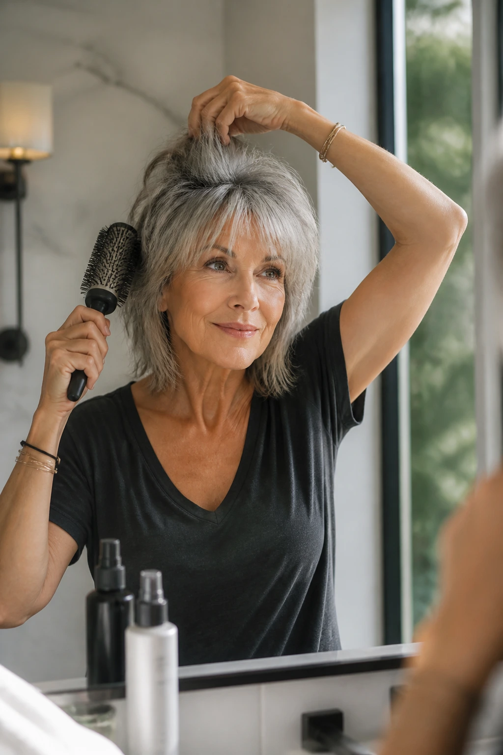 Older woman styling rocker shag with crown lift in bright bathroom