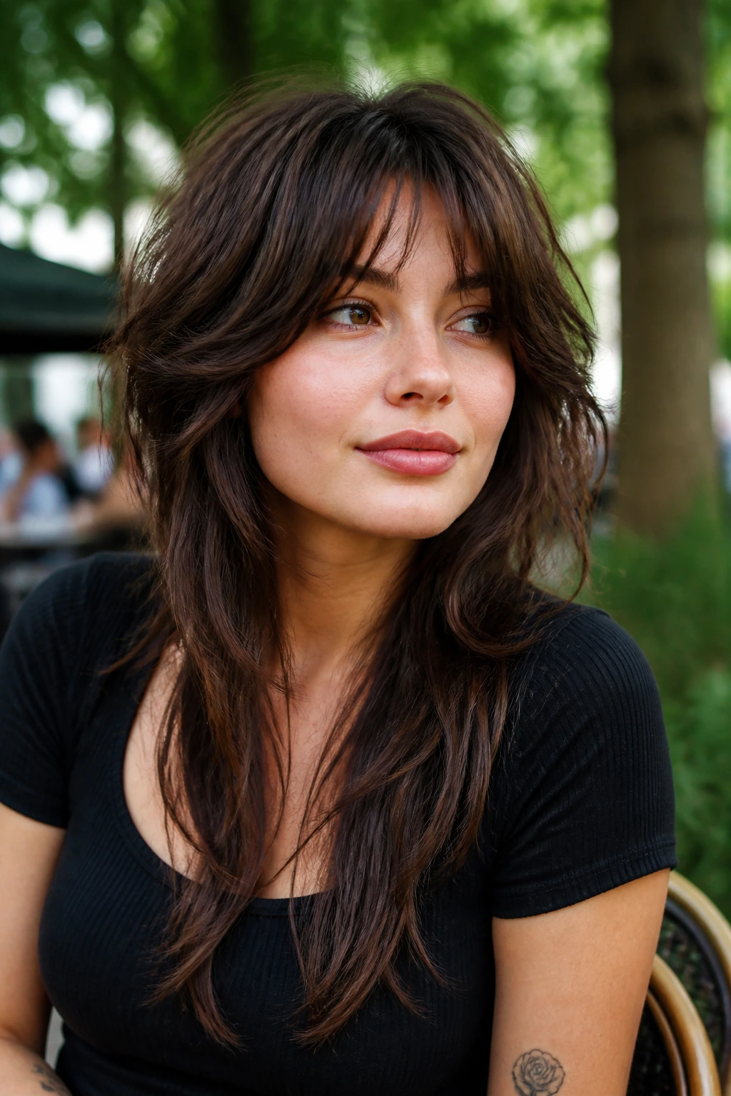 Portrait of a real woman with a round-face balancing shag featuring longer sides.