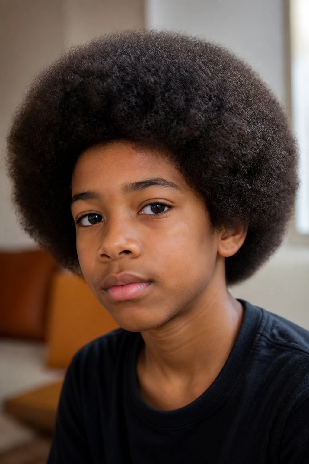 Close-up of a real person with a rounded long Afro, balanced silhouette and soft outline.