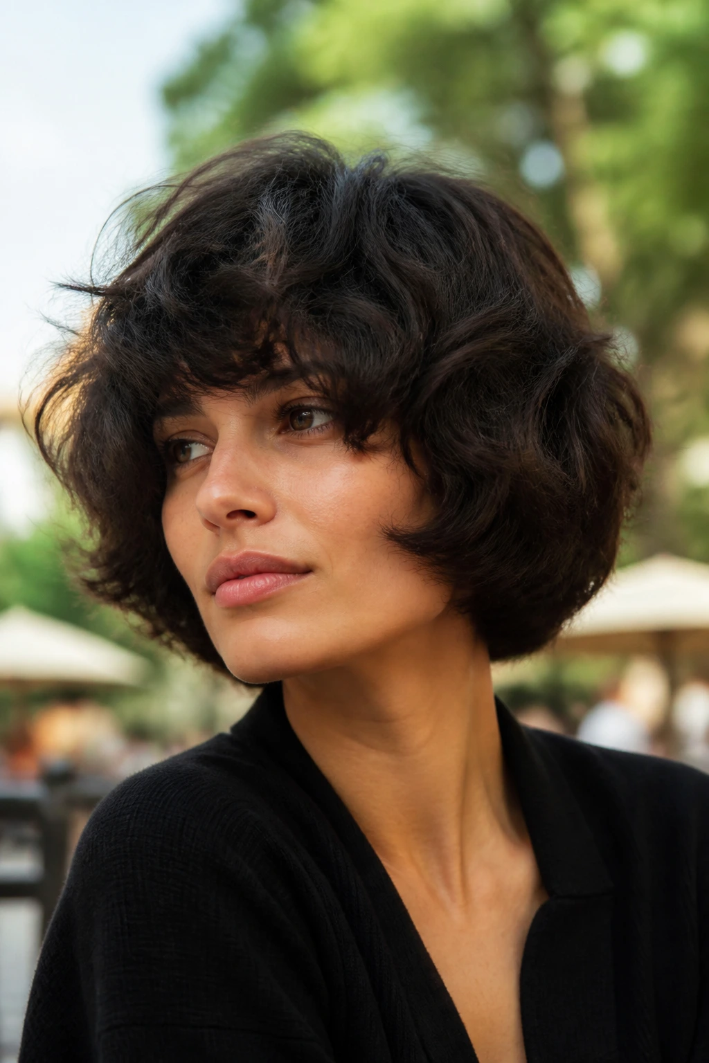 Close-up of a real woman with rounded mushroom shag bob in natural outdoor light