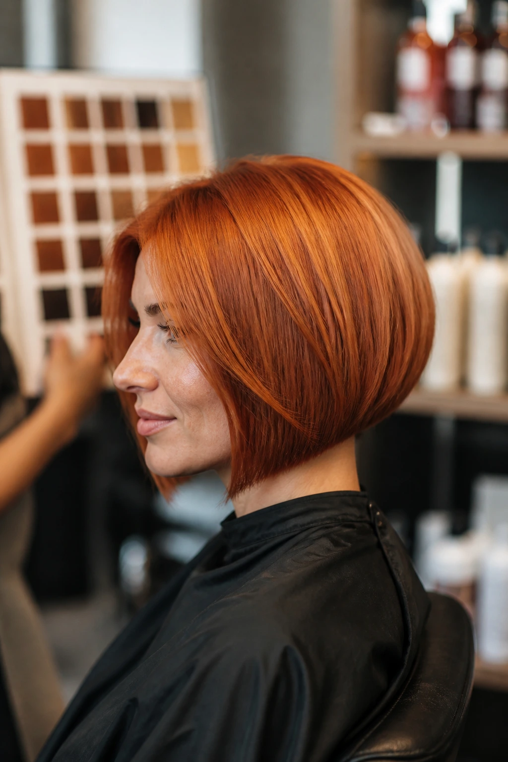 Real person in a salon with copper bob discussing color care