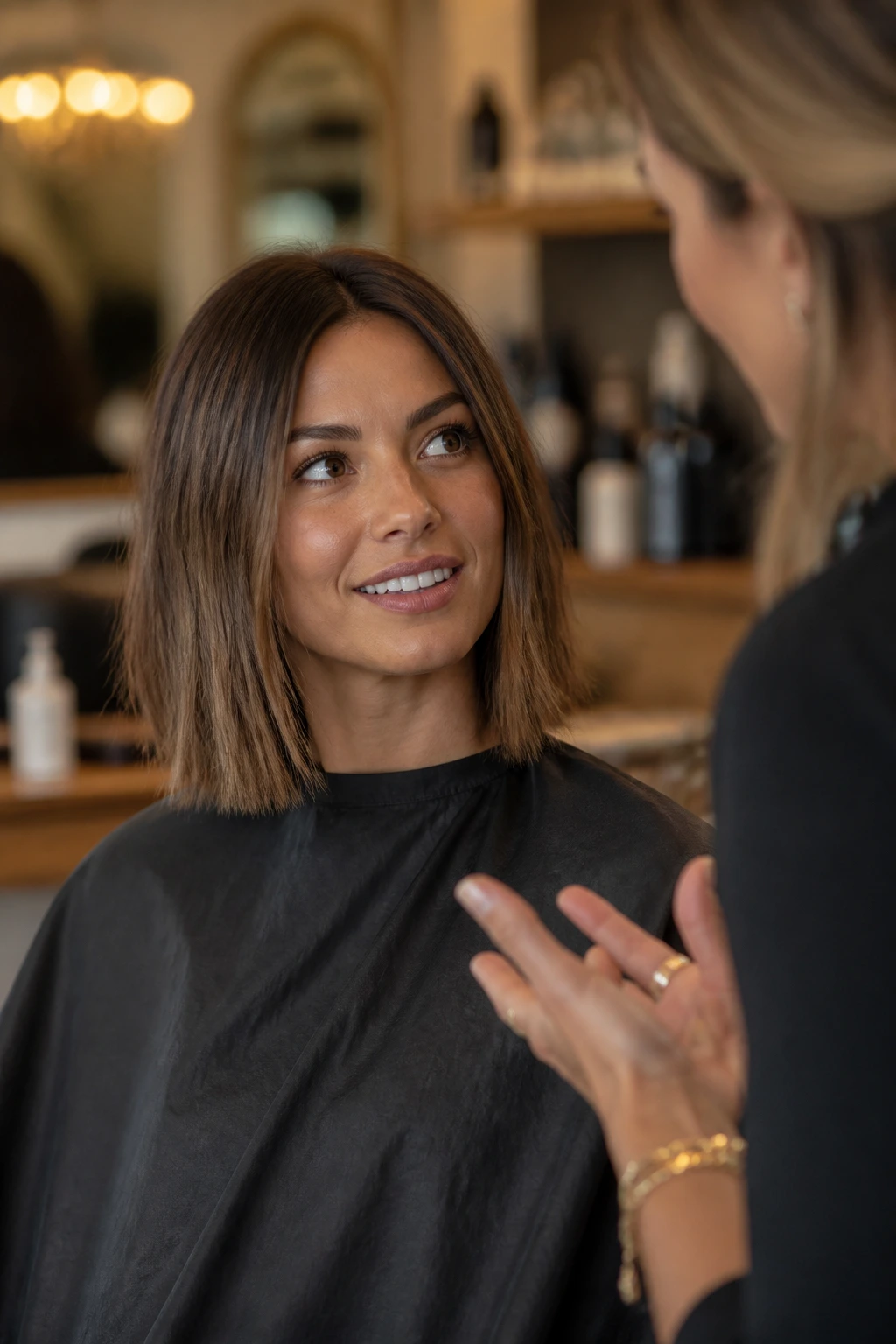 Portrait of a woman in a salon discussing straight-lob details