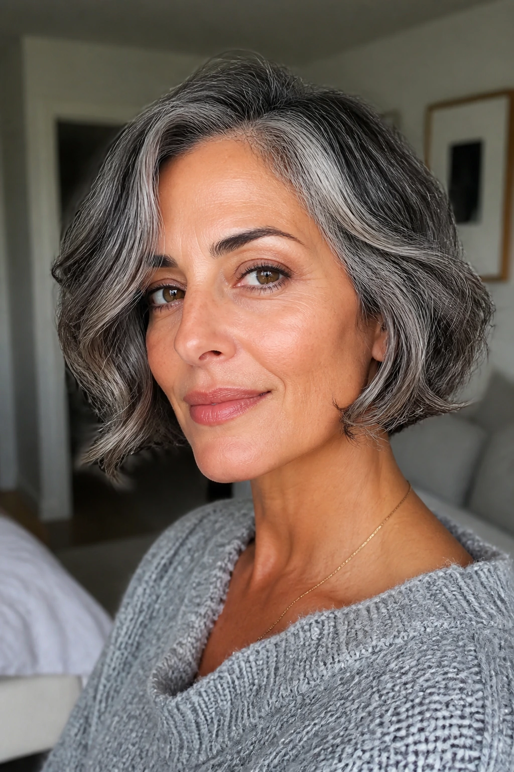 Close-up of a real person with salt-and-pepper Italian bob and soft bend