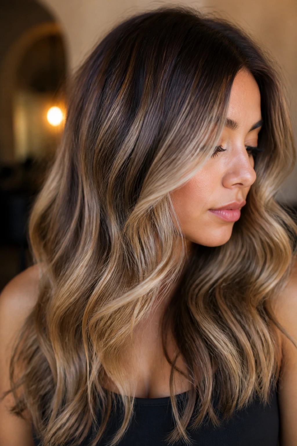 Medium brown hair with sandy blonde balayage.