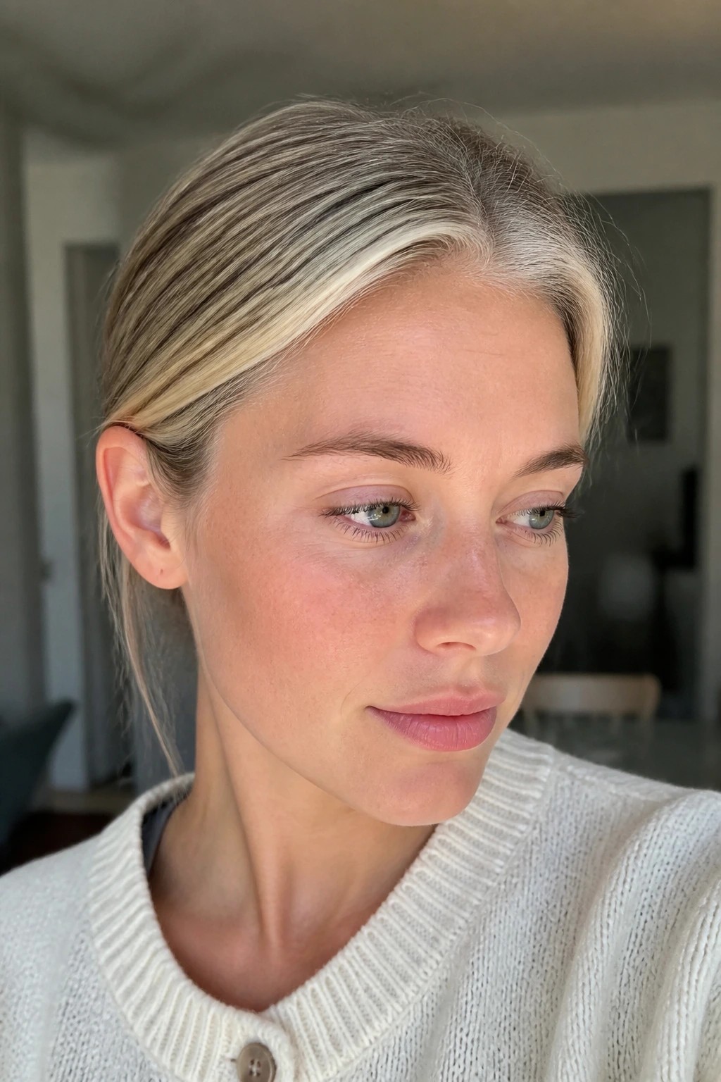 Close-up of a real woman with Scandi Hairline Blonde highlighting the front hairline.