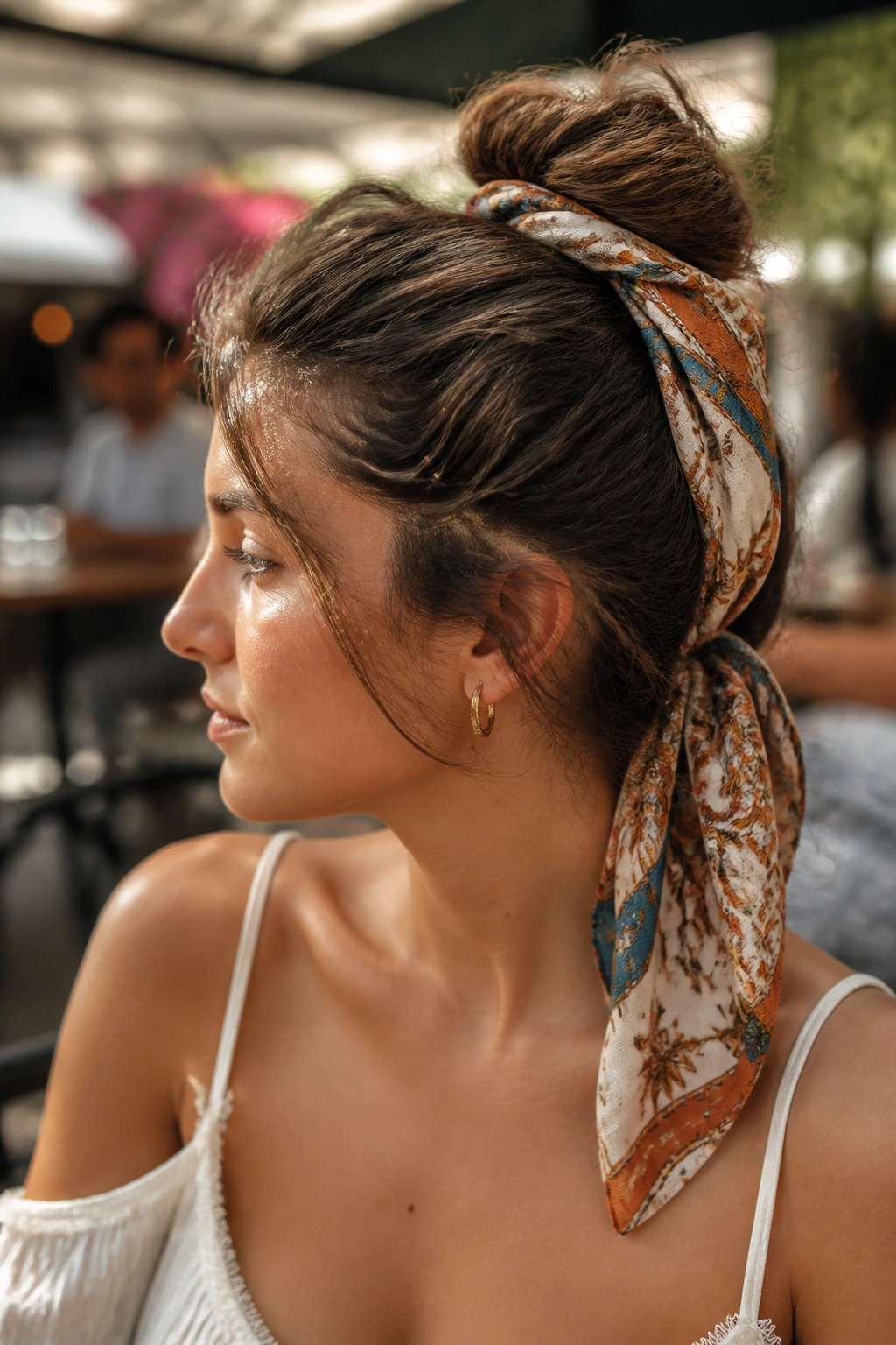 Portrait of a real woman wearing a scarf-wrapped bun outdoors