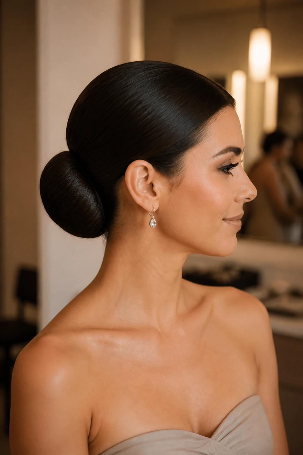 Close-up of a real woman with a sculpted ballet bun and an ultra-polished look