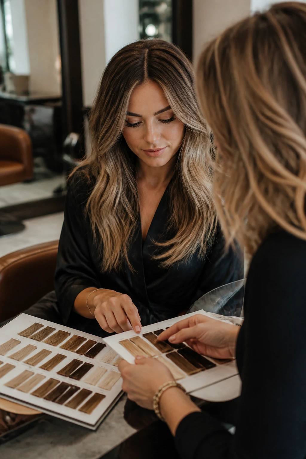 Real woman in salon chair during shade consultation with color swatches