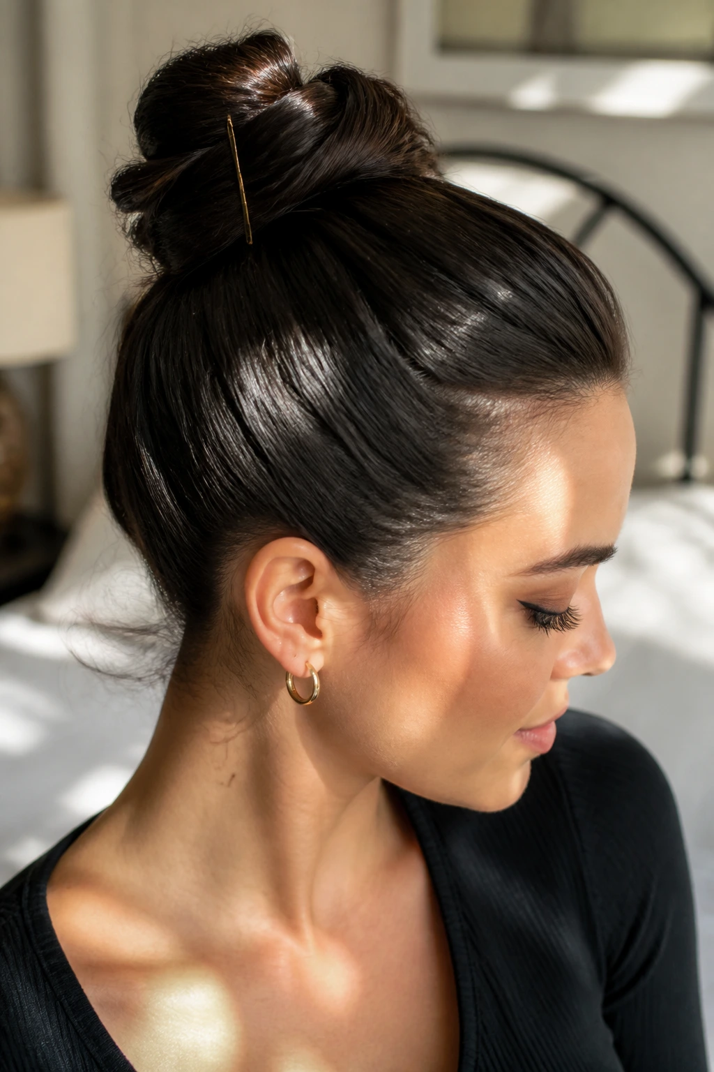 Close-up of a real woman with a short-hair high bun held by pins