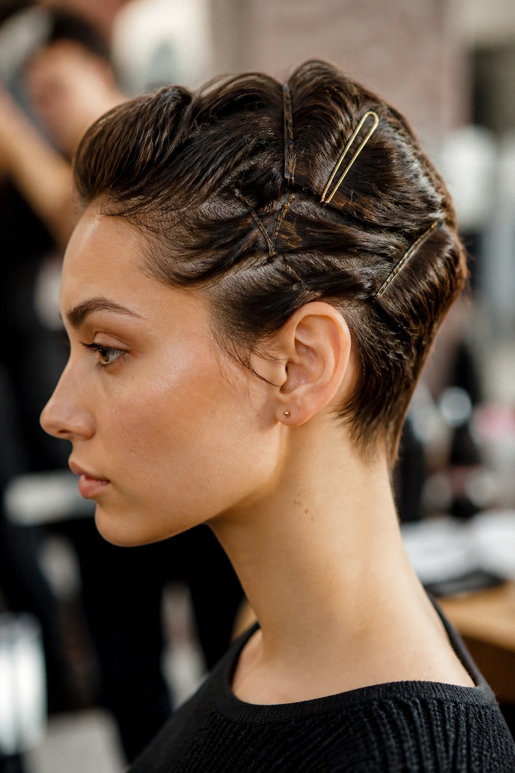 Real-person portrait showing a secure short-hair updo with multiple pins.