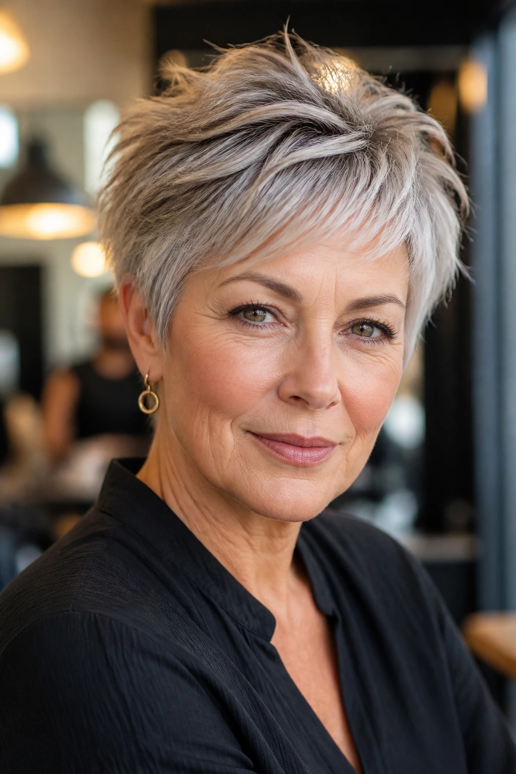 Close-up of an older woman with a textured short haircut that lifts the crown