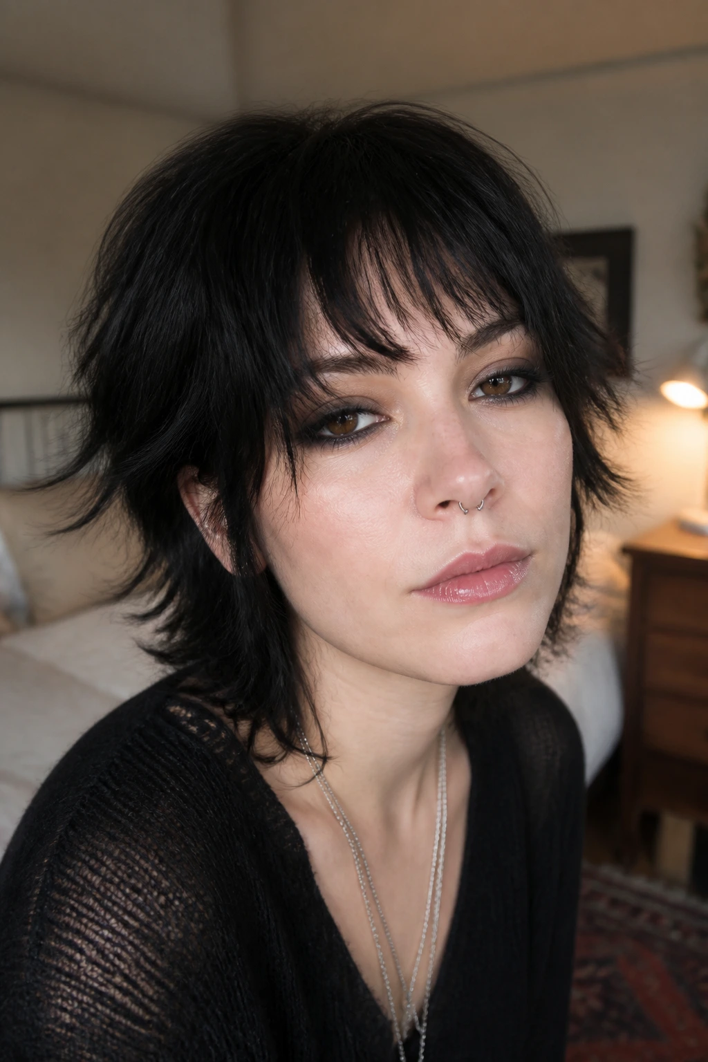 Real person with feathered short shag bangs in soft window light