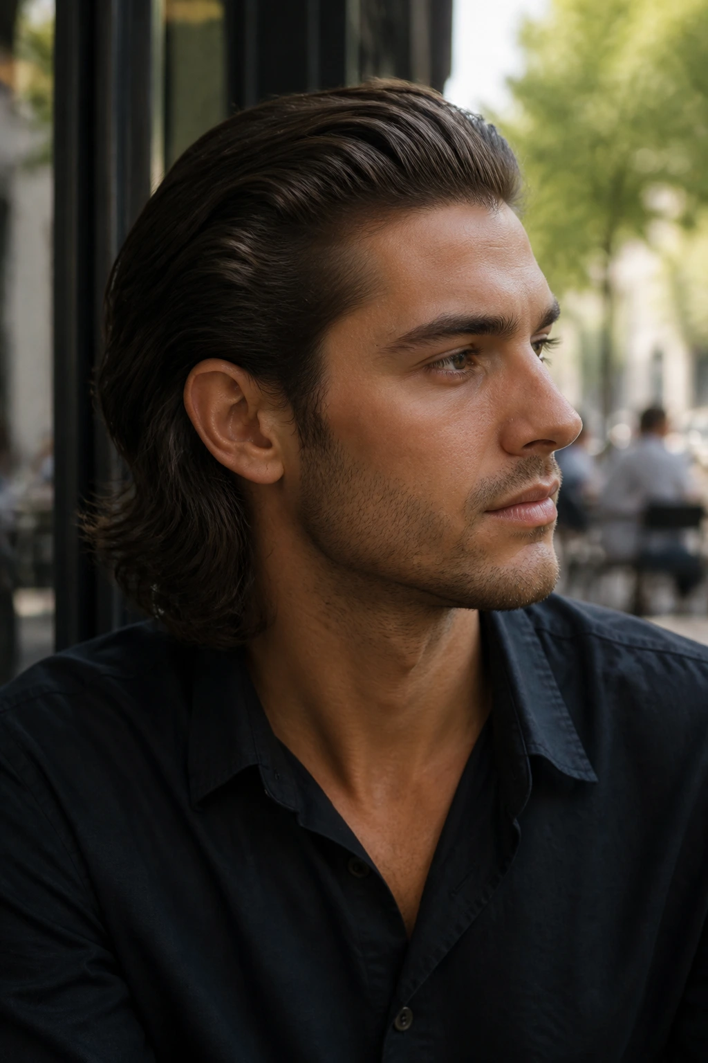 Close-up of a real person with shoulder-length slick-back hair outdoors by a cafe window