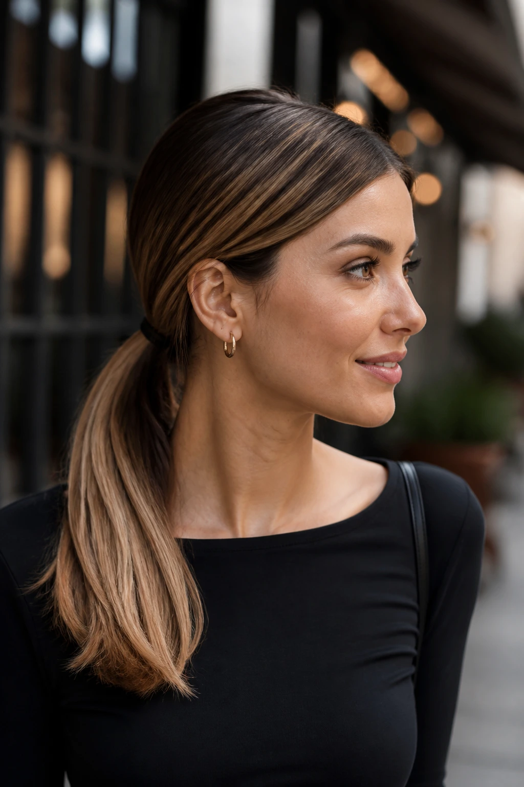 Real person with a side-part low ponytail in warm daylight