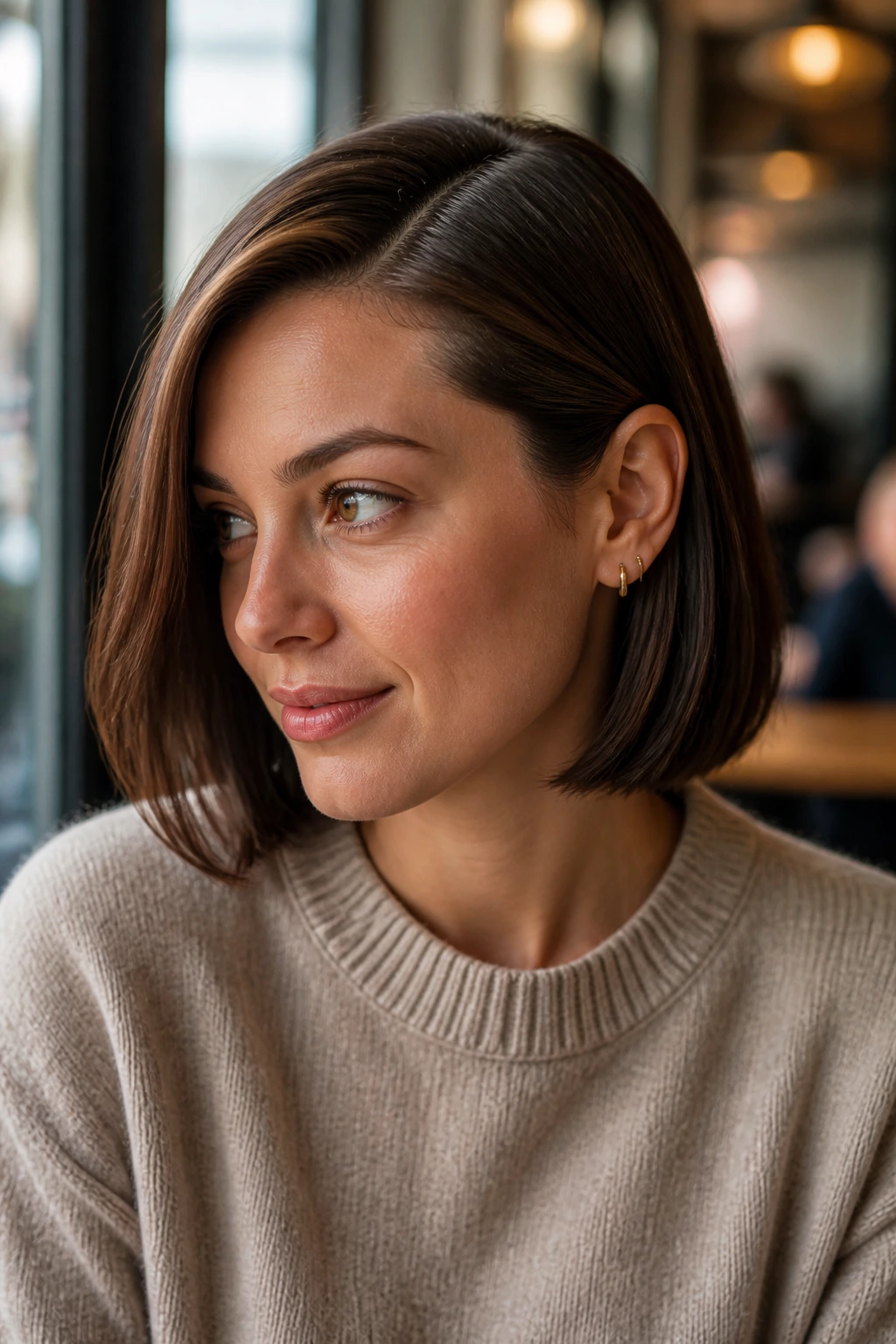 Portrait of a woman with a side part tucked behind the ear