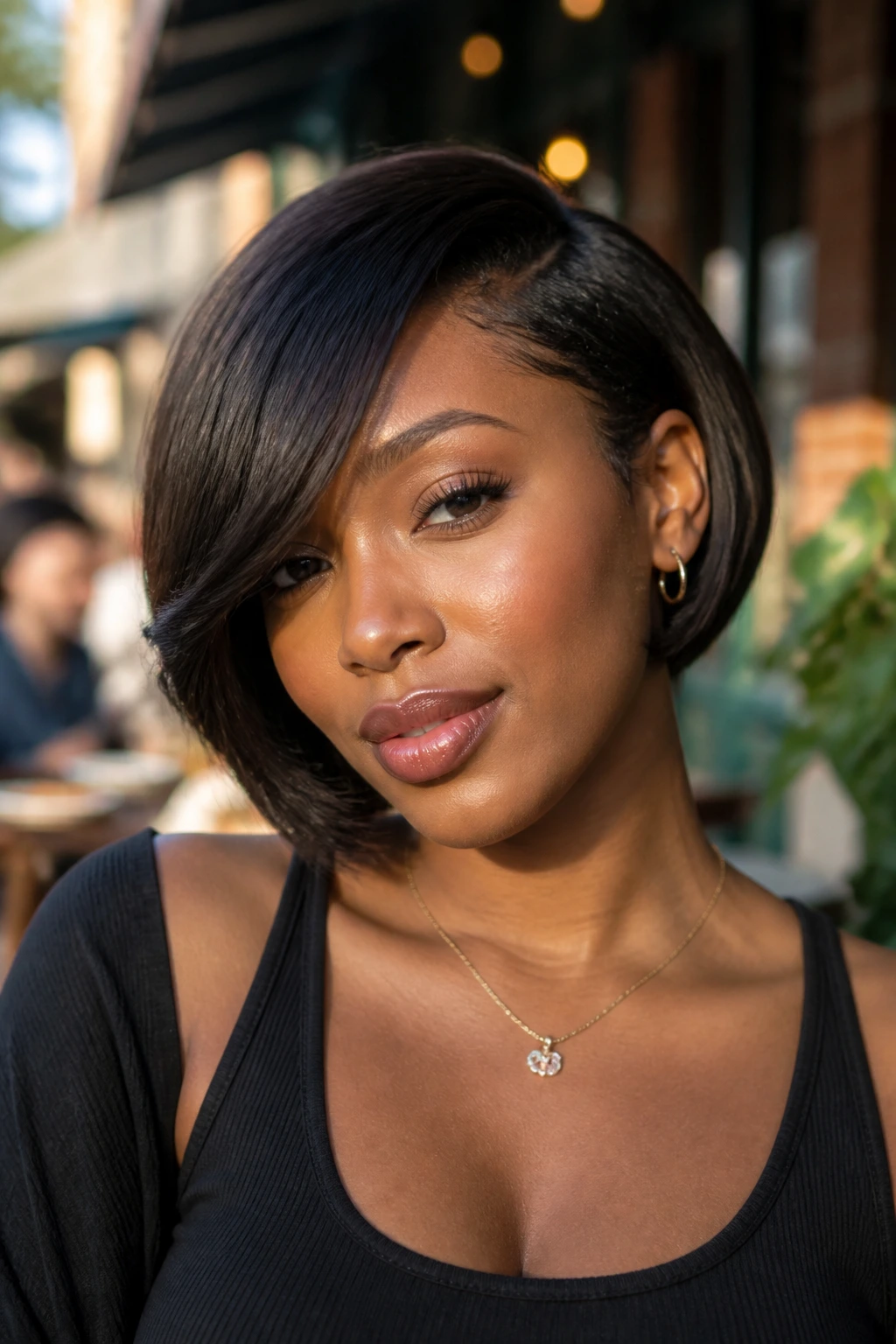 Close-up portrait of a real Black woman with a side-swept fringe bob near the cheekbone in late sun