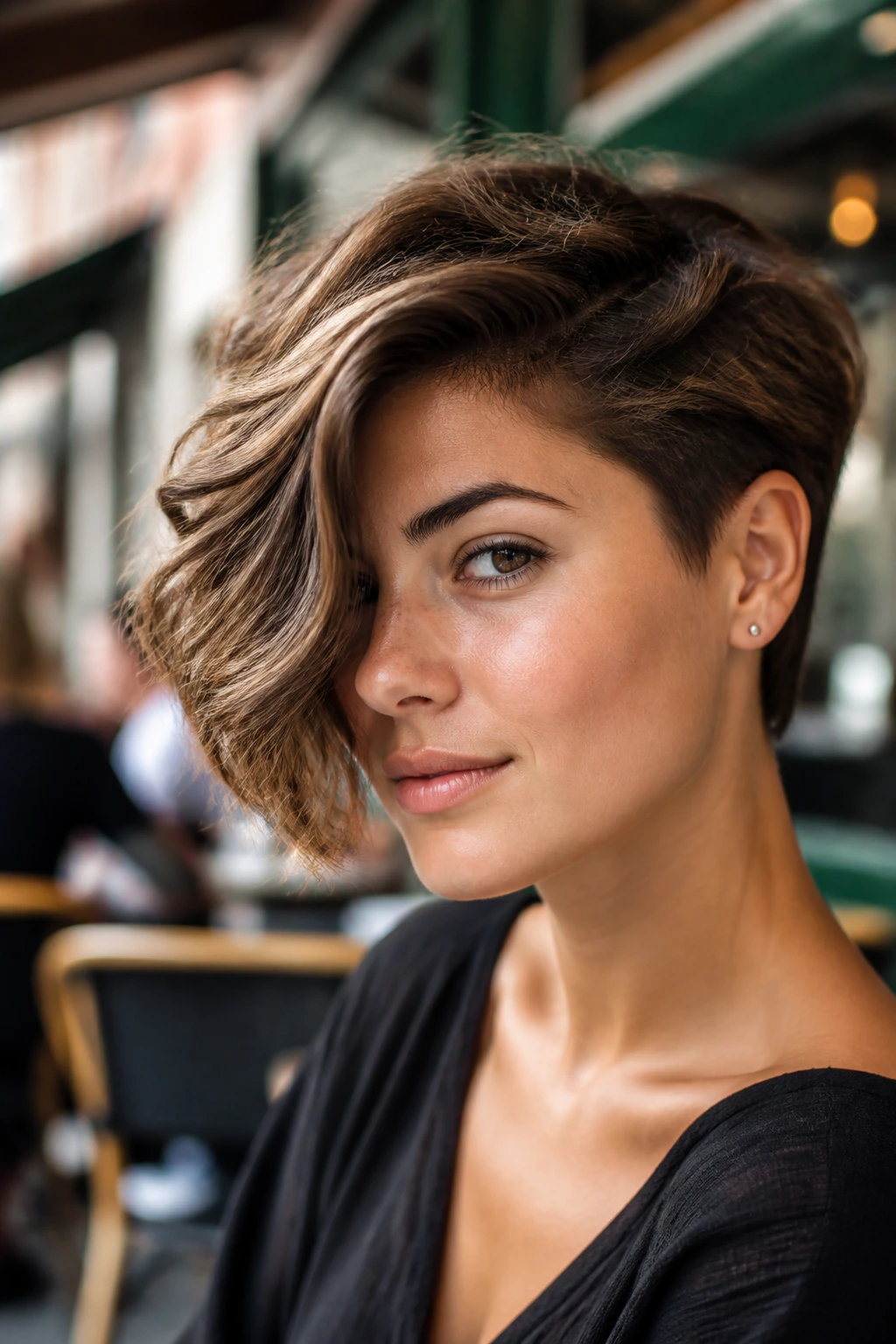 Close-up portrait of a real person with a side-swept wave crop hairstyle
