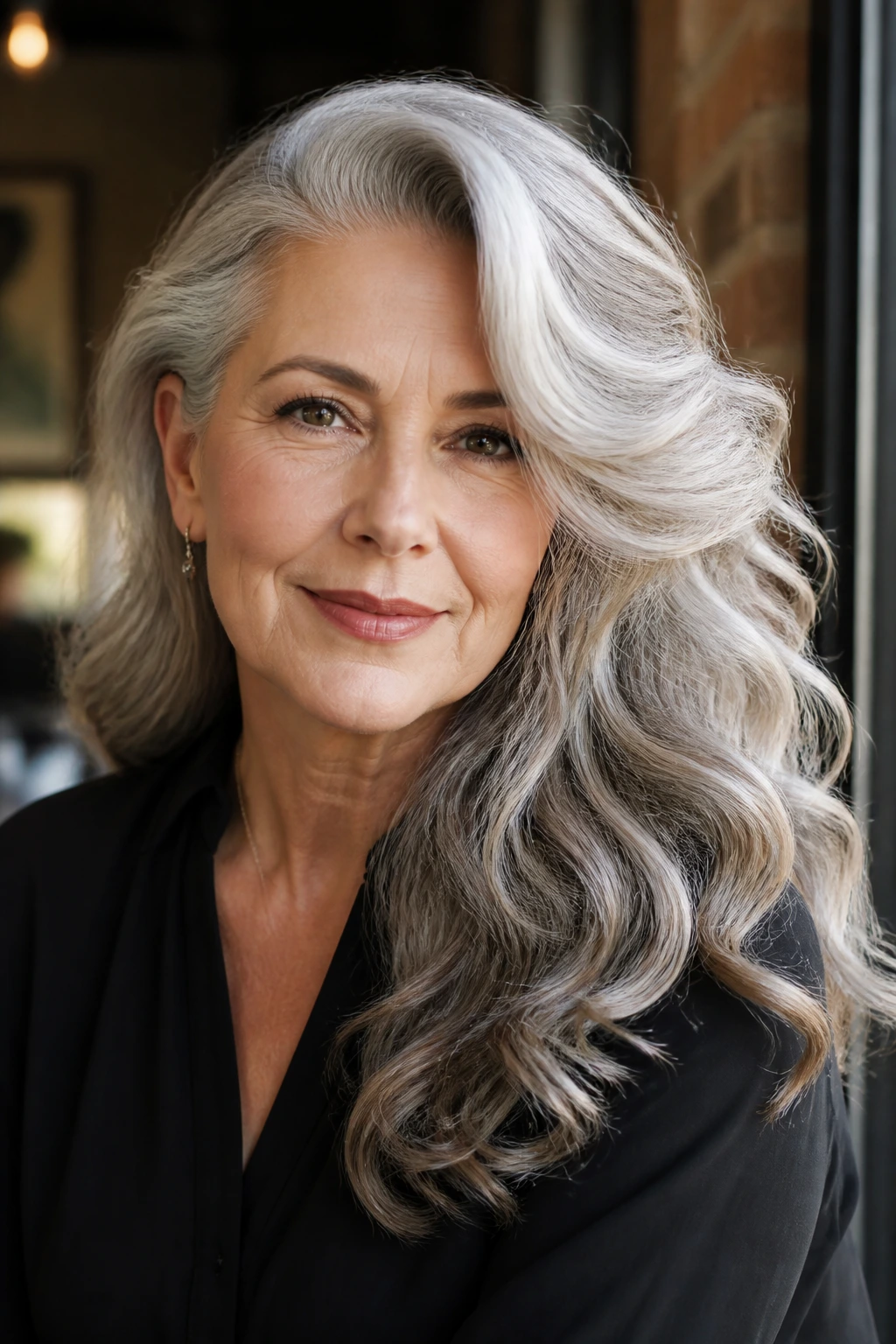Real woman with side-swept Hollywood waves in soft natural light.