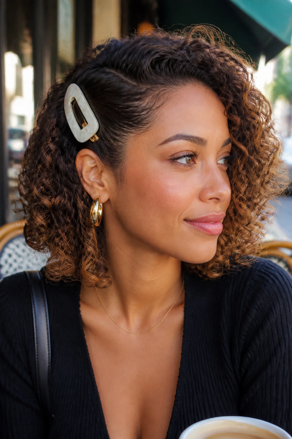 Real woman with a side tuck secured by a bold clip.