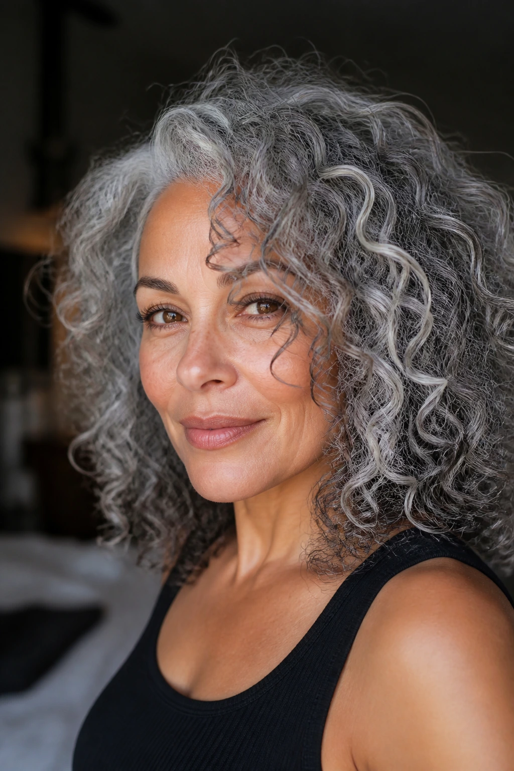 Portrait of curly-haired person with dimensional silver tones.