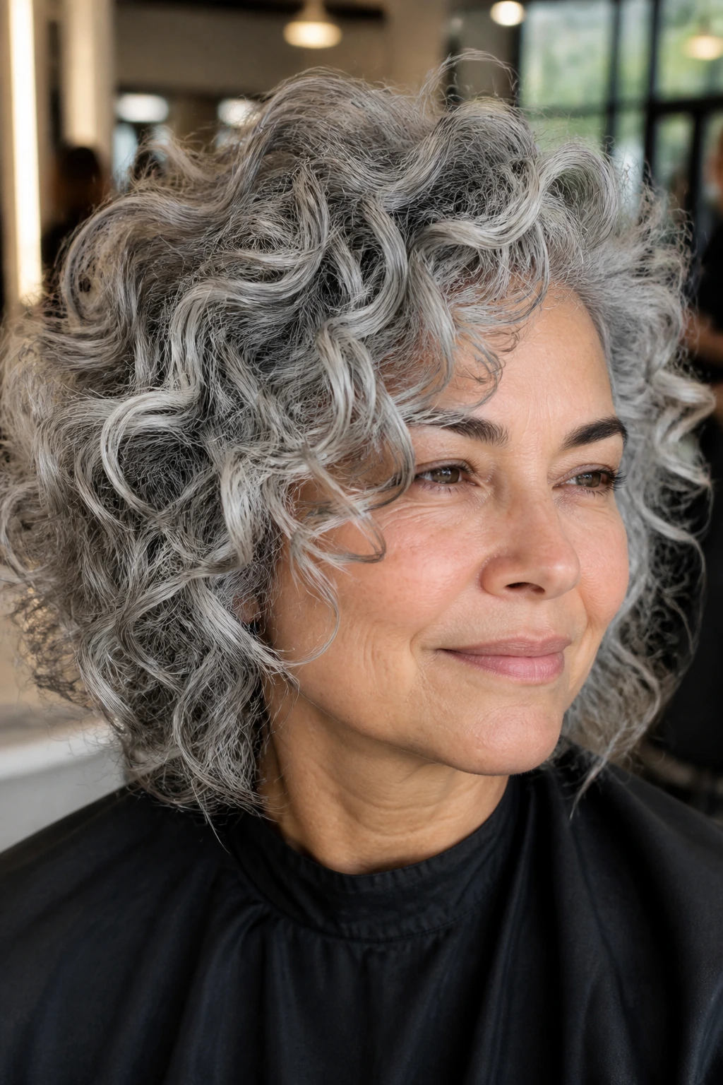 Close-up of a real woman with silver babylights in curls