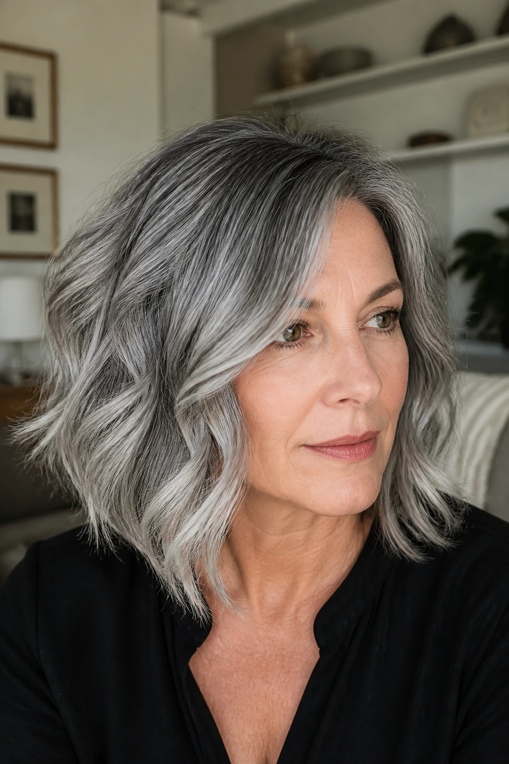 Close-up of a real woman with slate root shadow on a wavy lob