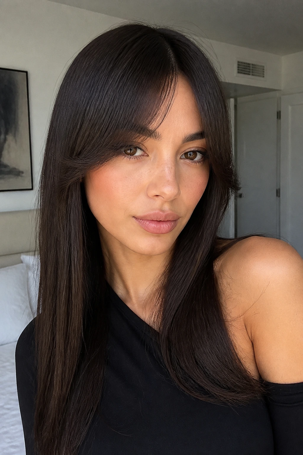 Close-up portrait of a real person with sleek curtain bangs on straight hair