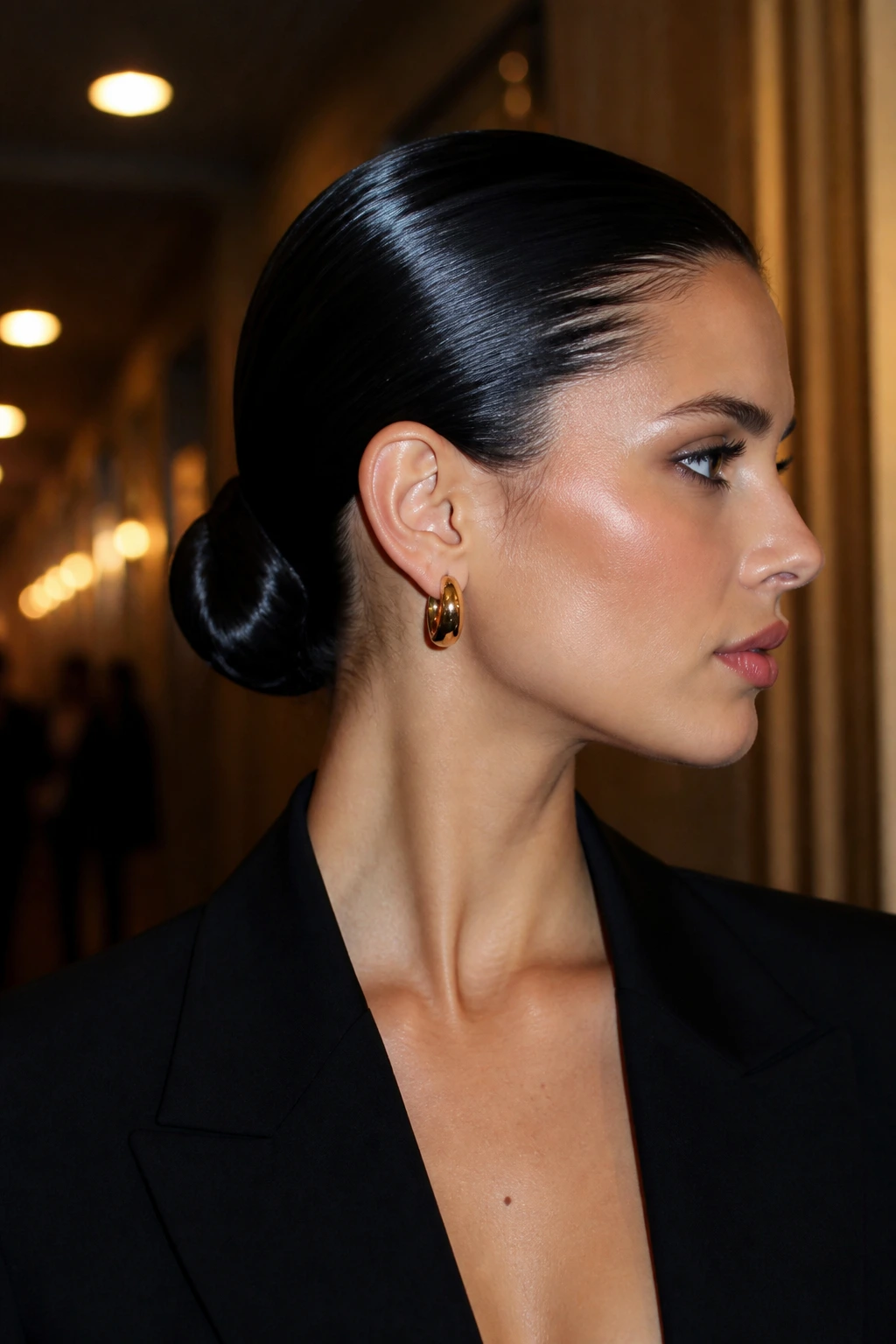 Close-up of a real woman with a sleek wet-look bun at the nape