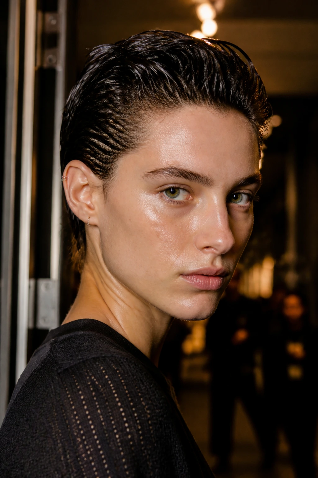 Close-up of a real person with a slicked-back wet look crop and glossy shine