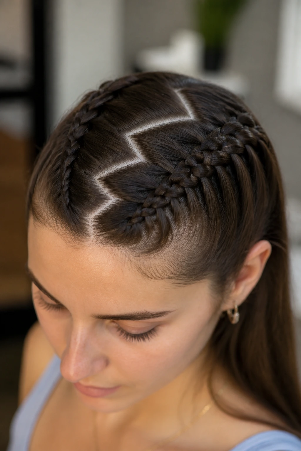 Real person with braided hairstyle showing zigzag part and subtle tweaks.