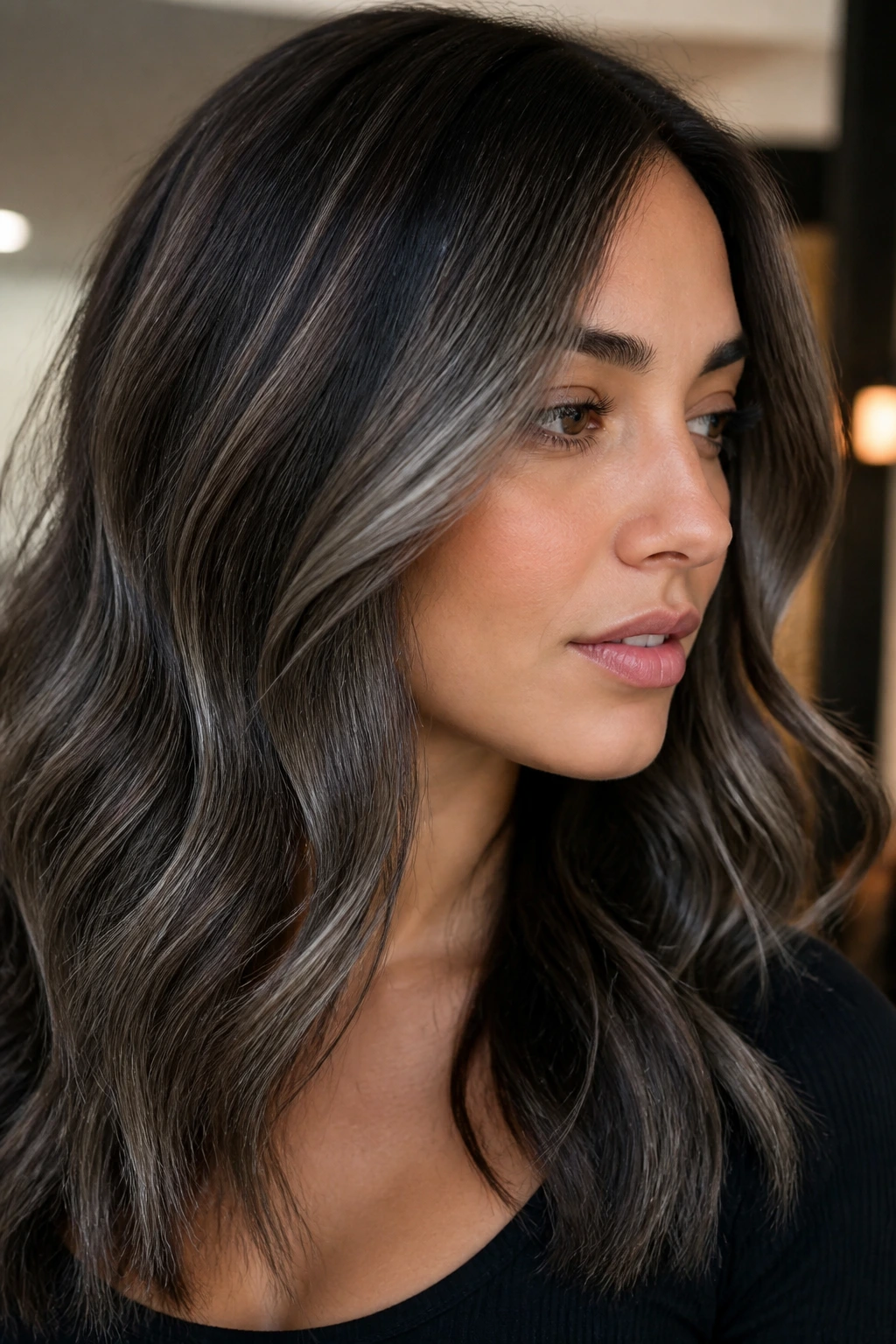 Brunette with smoky ash babylights creating cool ribbons.