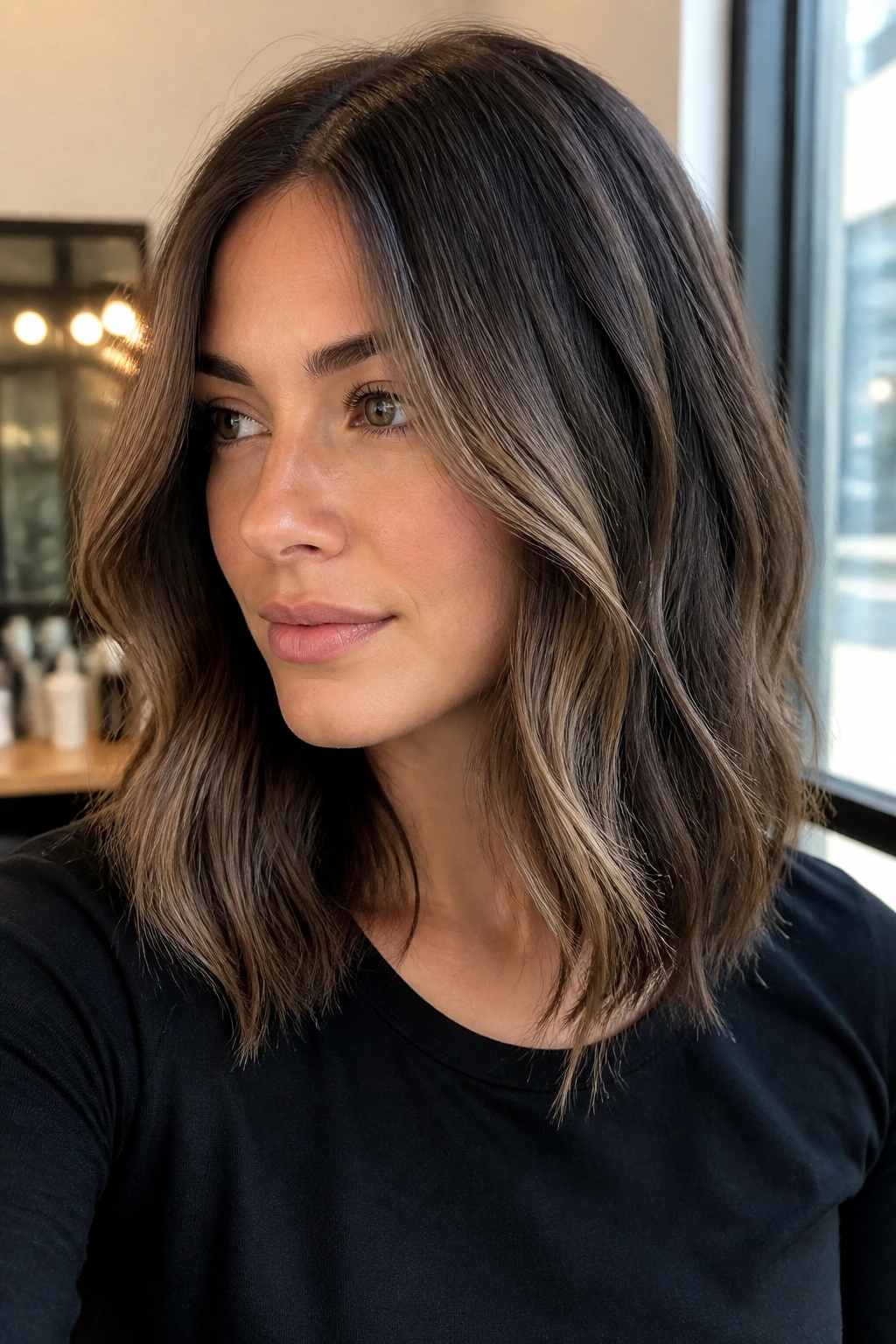Close-up of smoky brunette with a face-framing highlight