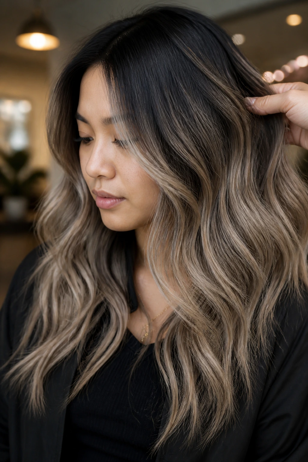 Real person with black hair transitioning to smoky mushroom blonde in indoor light