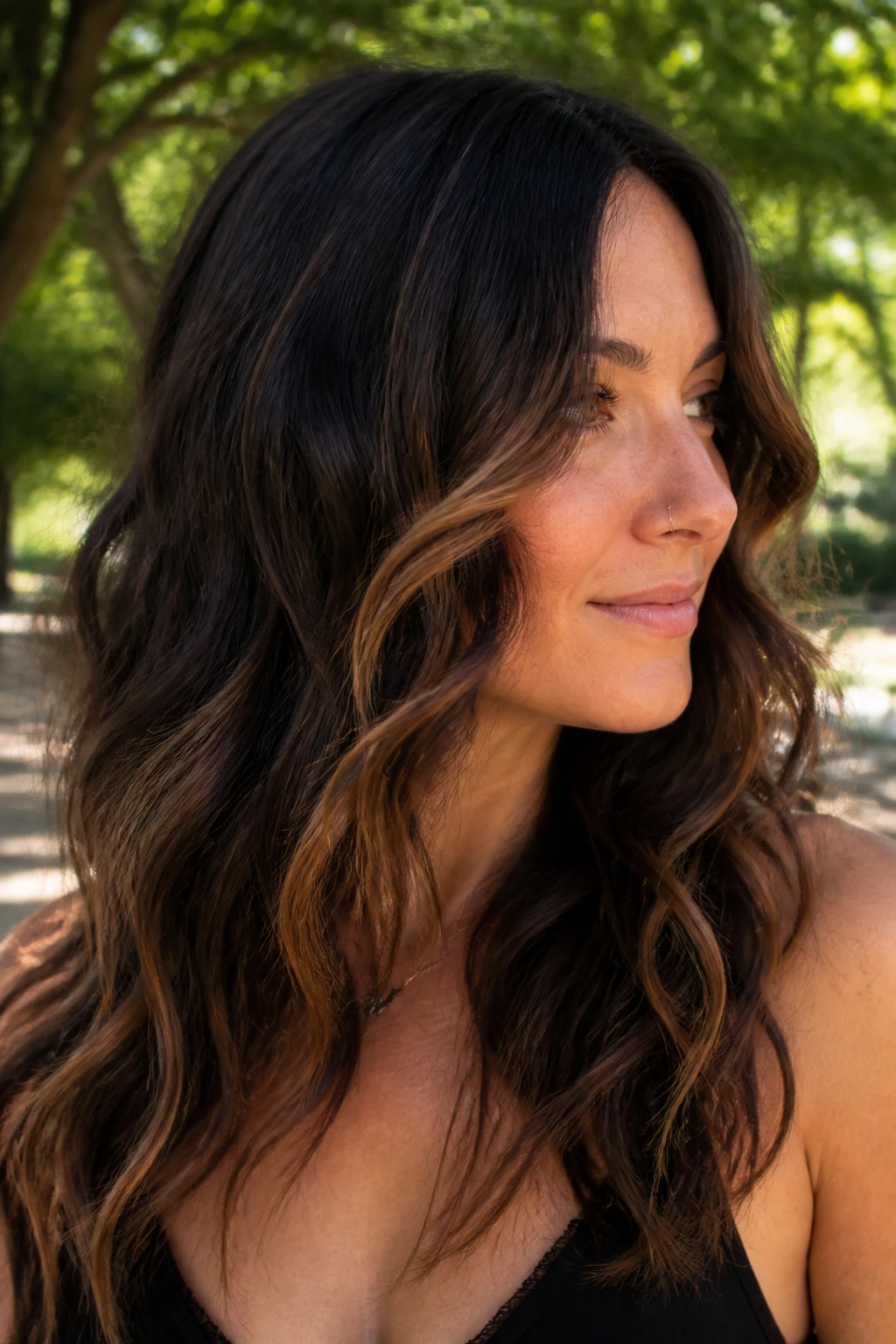 Close-up of woman with caramel peekaboo frame visible through waves