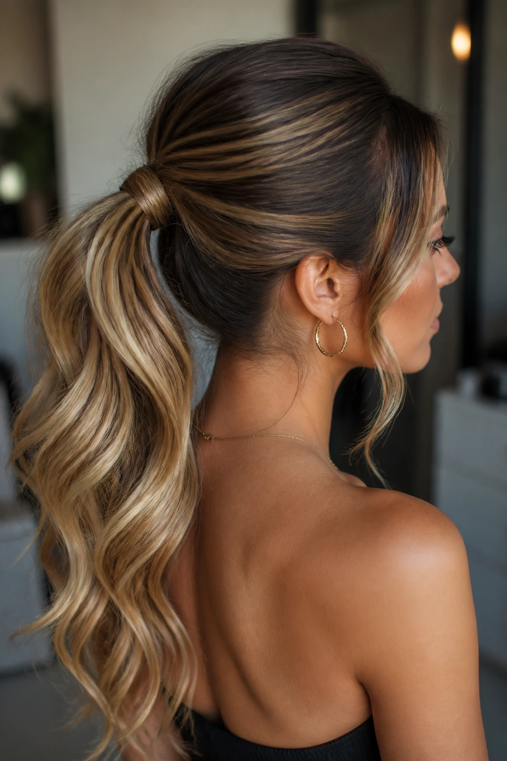 Soft glam ponytail with waves on a real person