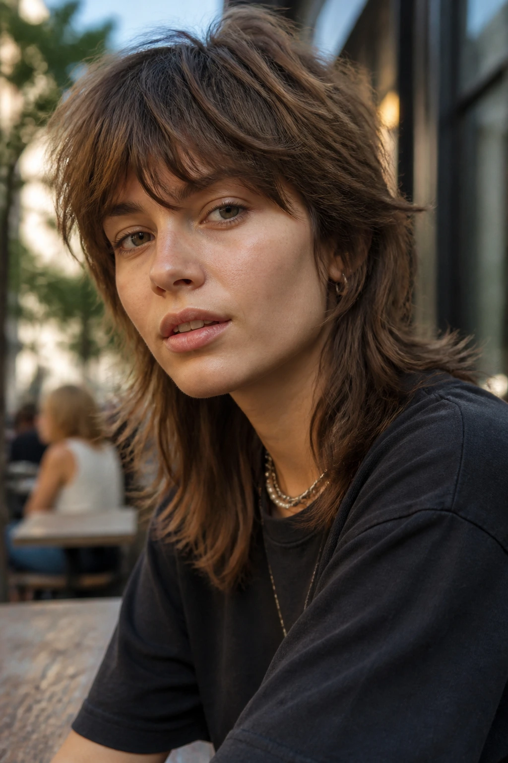 Portrait of a person with a soft mullet shag in an urban cafe