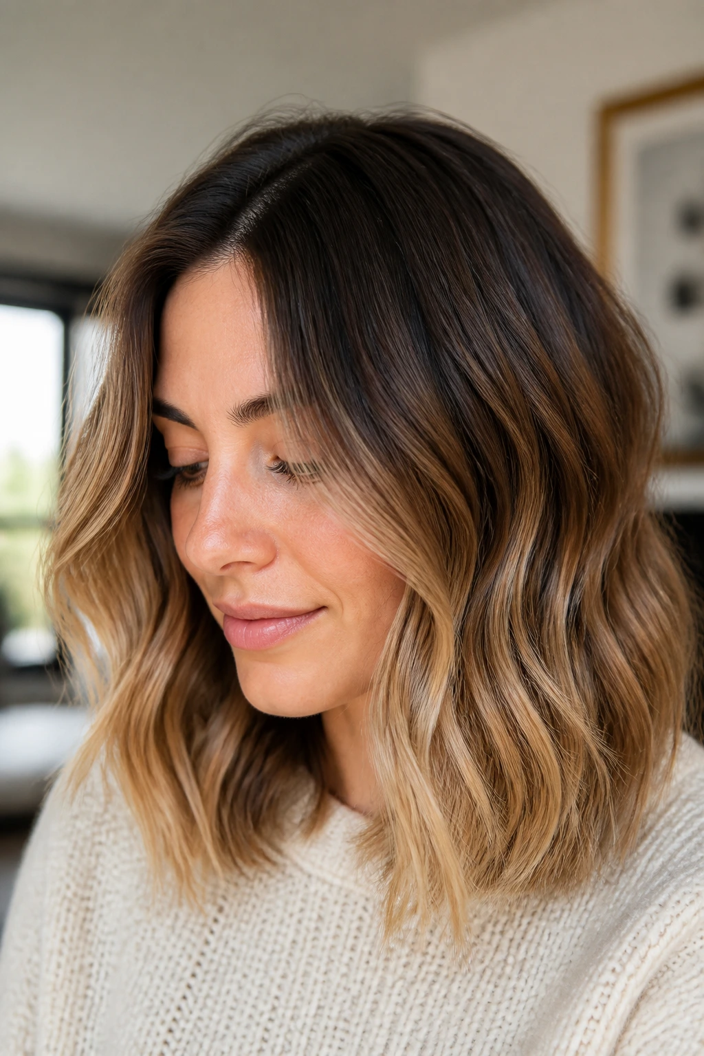 Portrait of a woman with shoulder-length hair styled to showcase a soft ombre fade