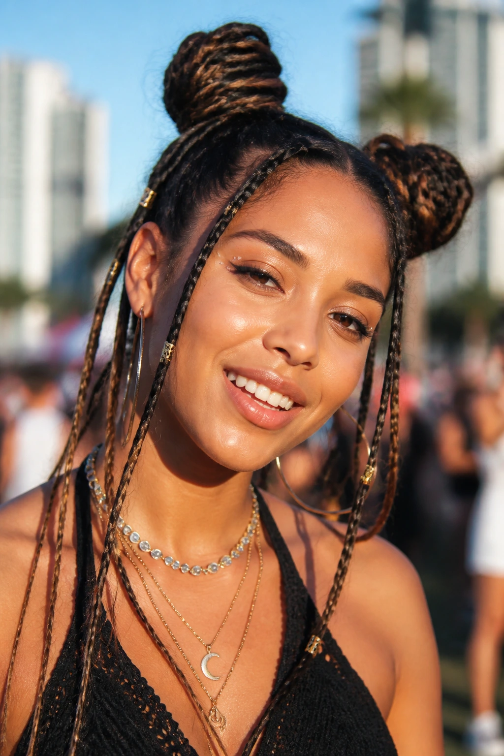 Portrait of a real person with space buns and mini braids in sunny outdoor festival setting.