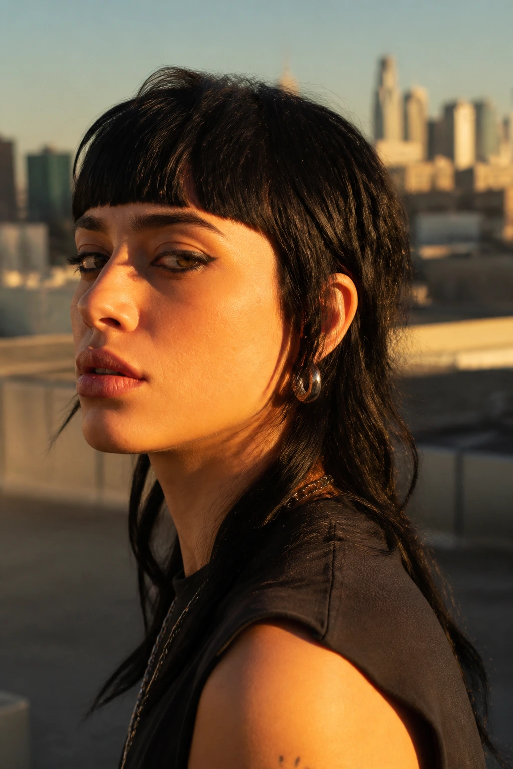 Close-up portrait of a real person with a strong fringe mullet on a rooftop at golden hour