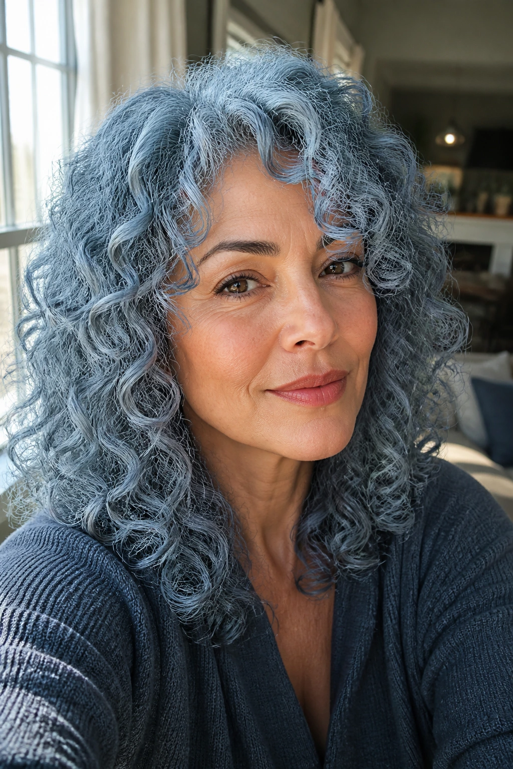 Close-up portrait of a real woman with steel blue silver curly hair in natural daylight