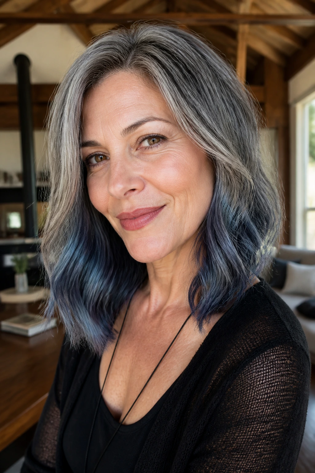 Close-up of a real woman with shoulder-length gray hair and steel blue smoky ends