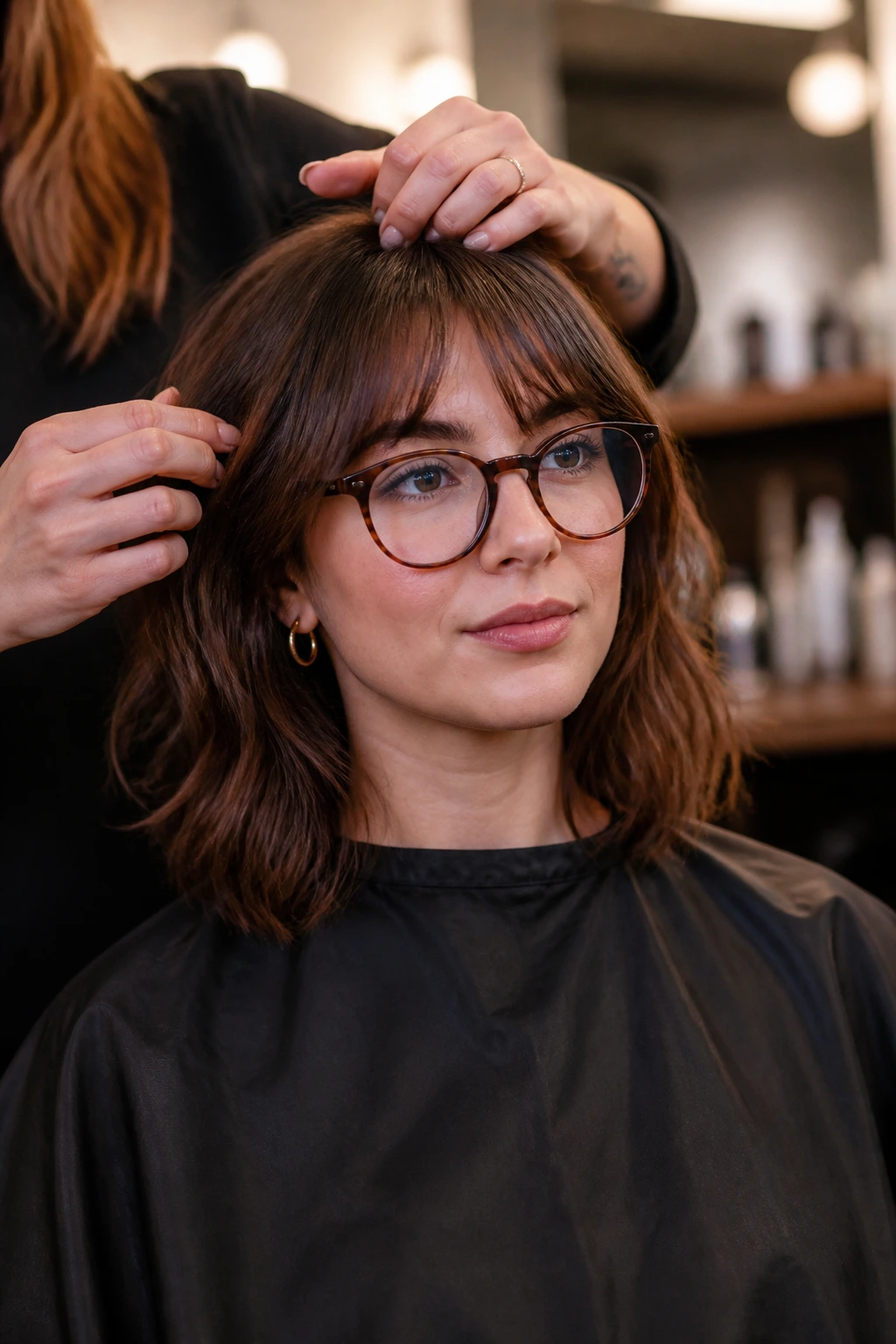 Salon client with glasses in discussion with stylist about bangs