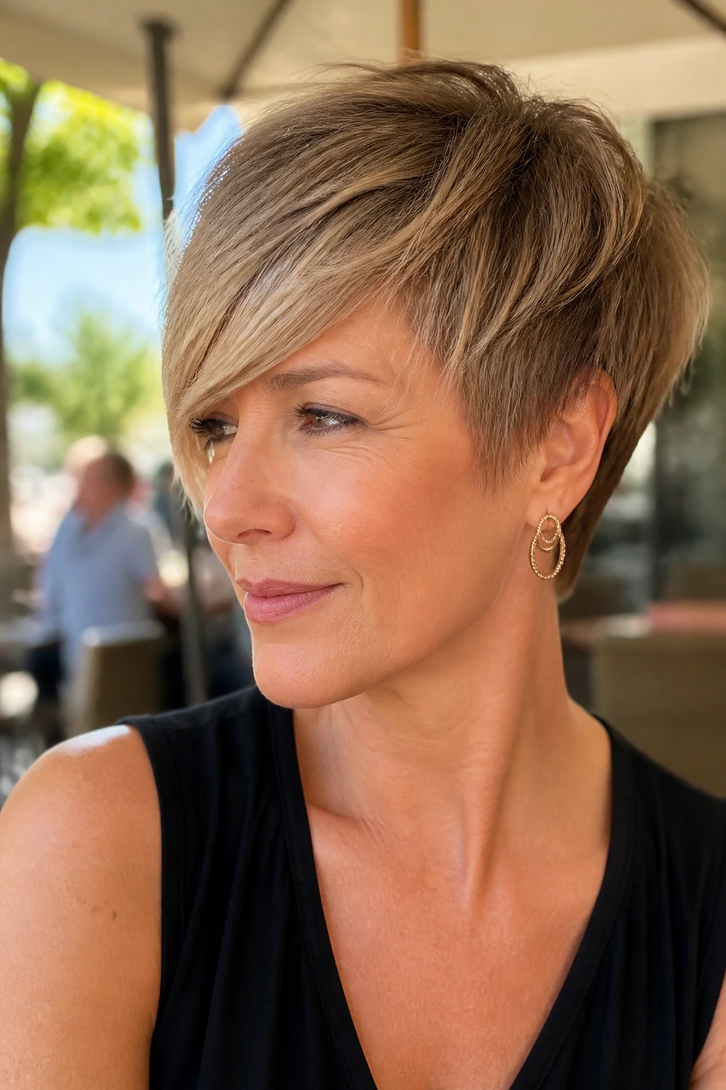 Real woman with swoopy crop and side fringe in outdoor cafe light