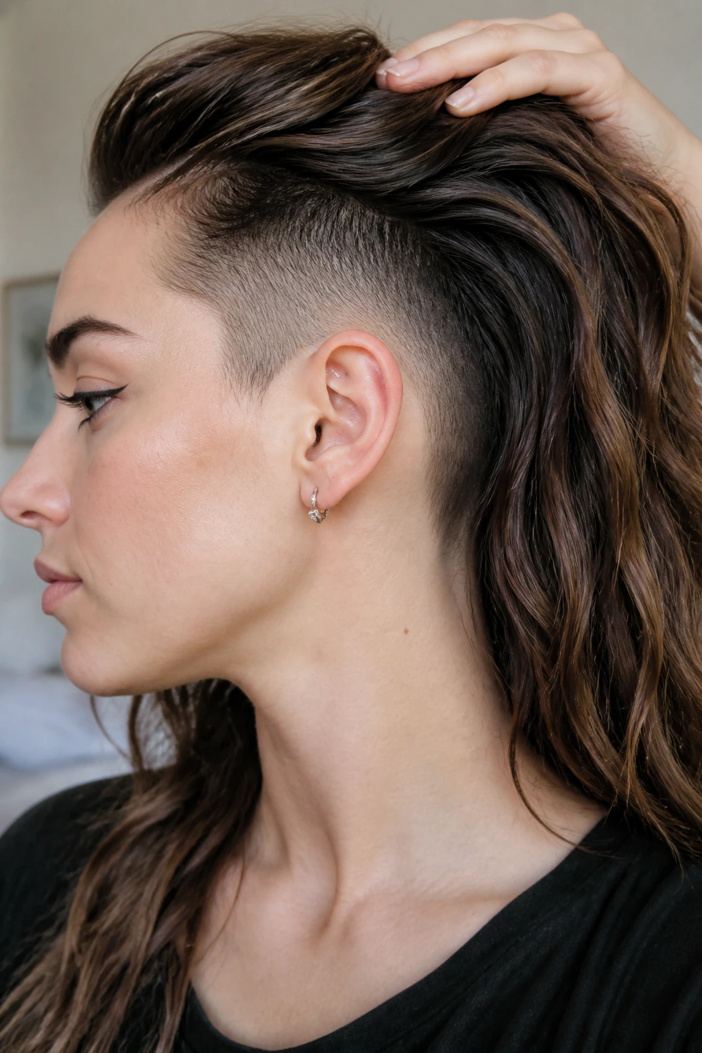 Close-up portrait of a woman with a tapered undercut blending into longer hair