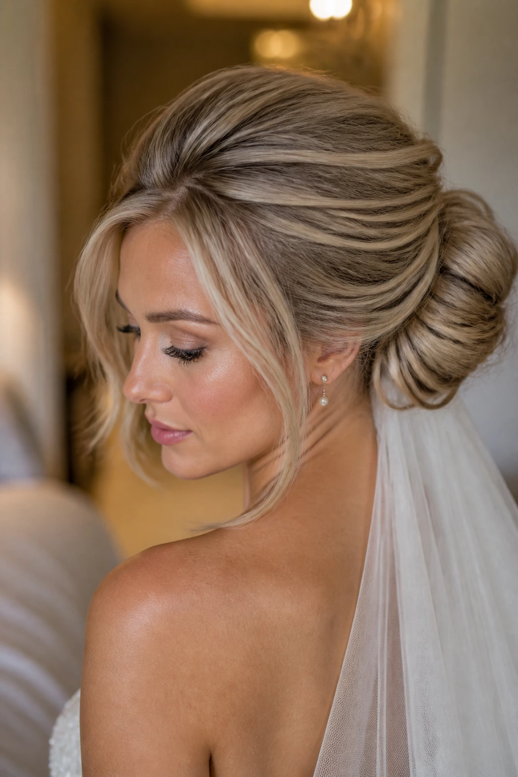 Close-up of a real bride with a teased crown and voluminous chignon.