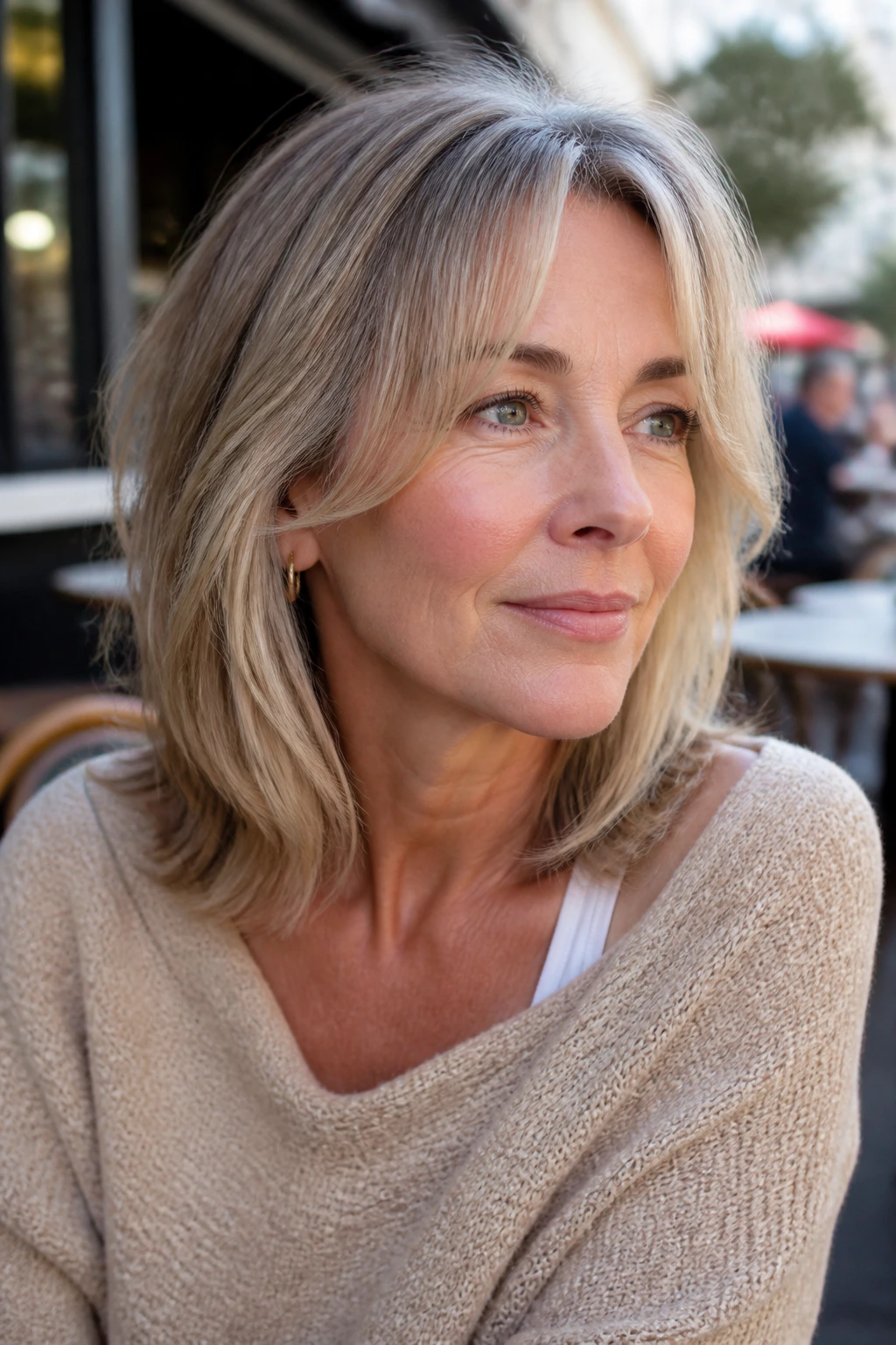 Close-up of a real woman with temple-to-cheekbone fringe framing the face