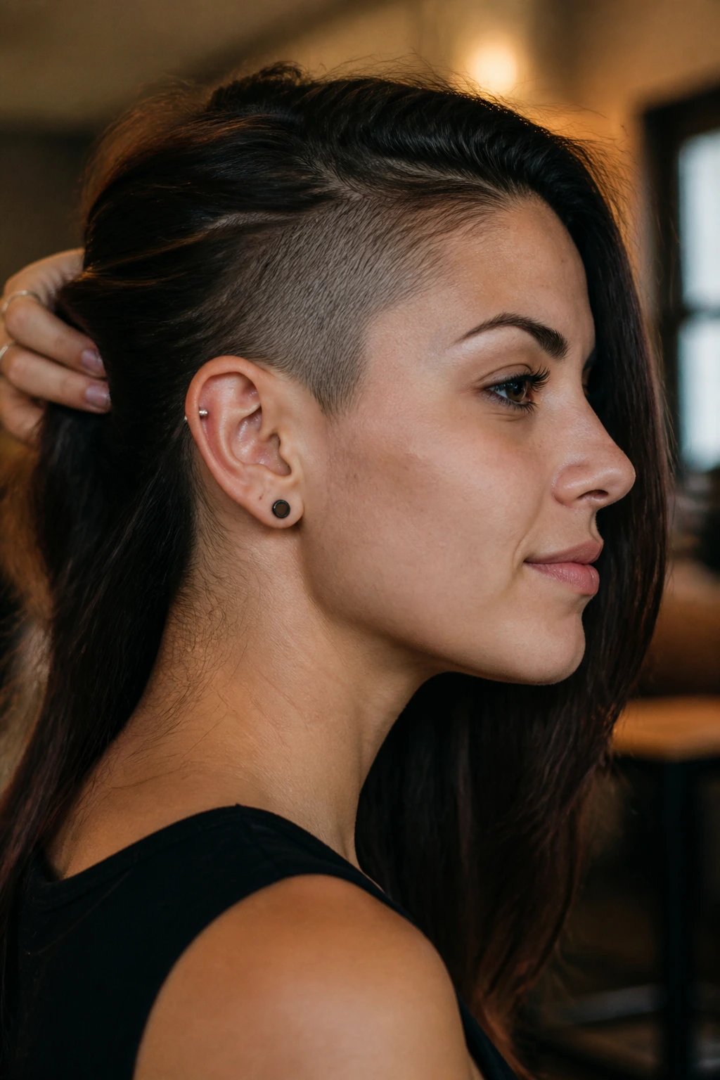 Profile view highlighting temple shave with hair tucked behind the ear