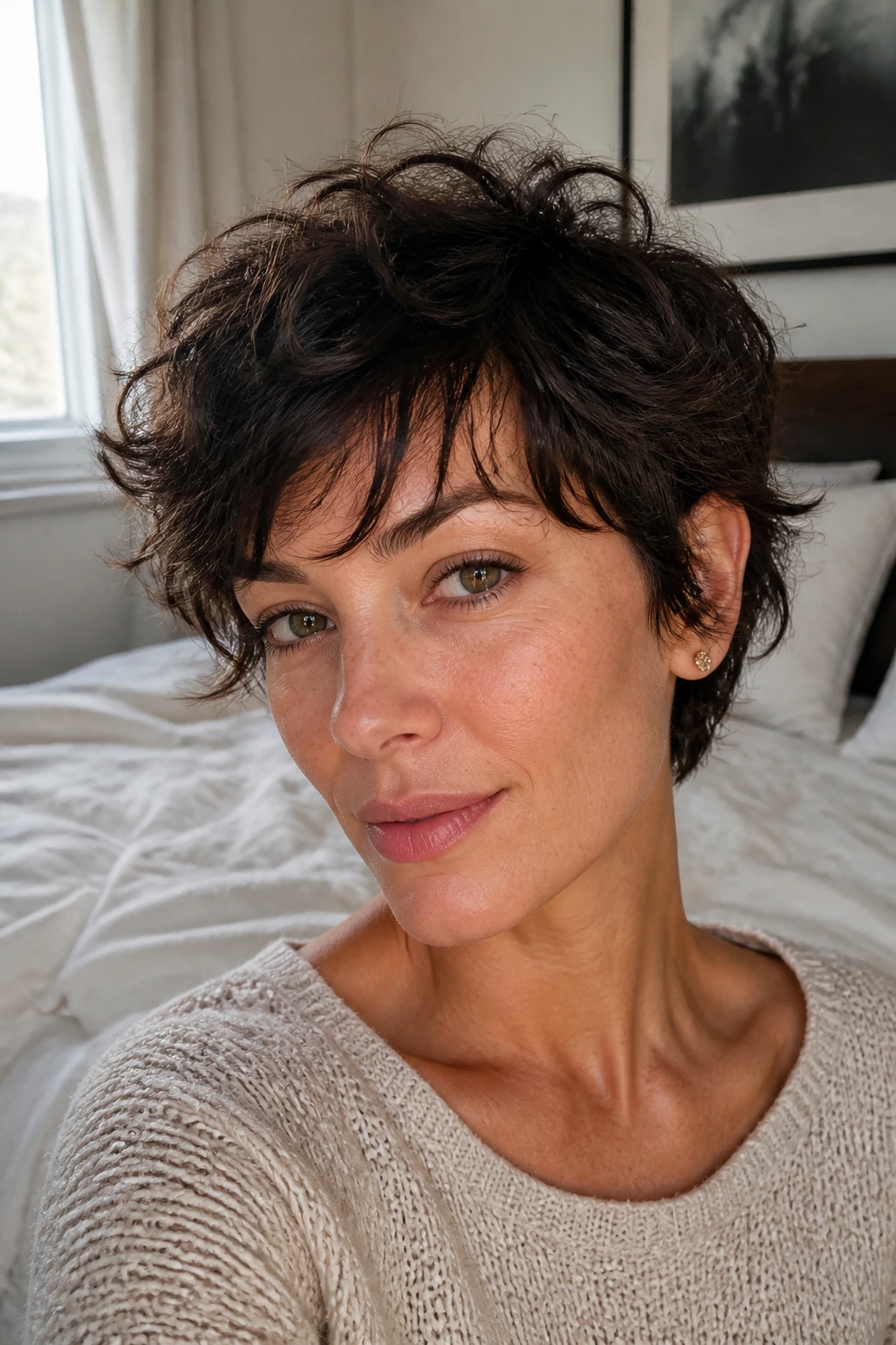 Close-up of a real woman with tousled bedhead pixie in a cozy bedroom
